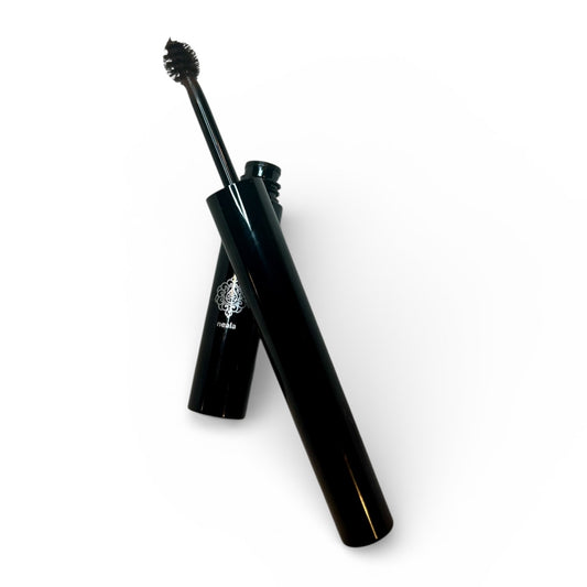 Black mascara with brush on a white background
