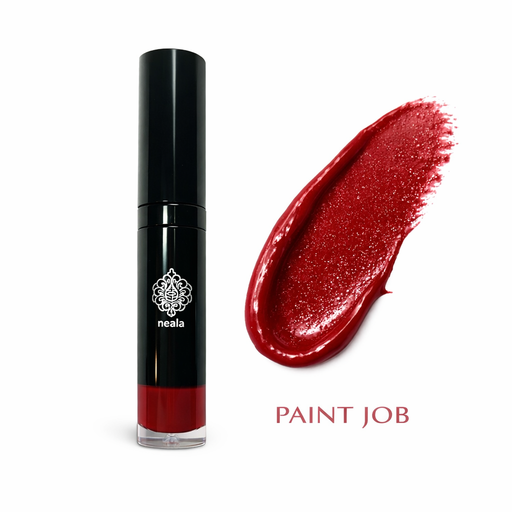 Red lip gloss with black applicator and a swatch of red color on a white background