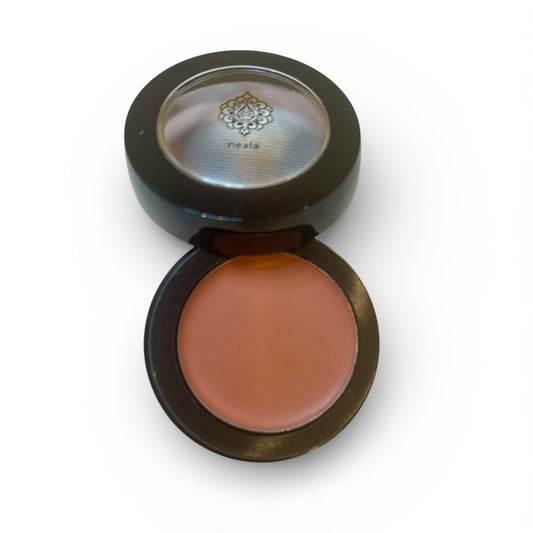 Compact blush in a black case on a white background