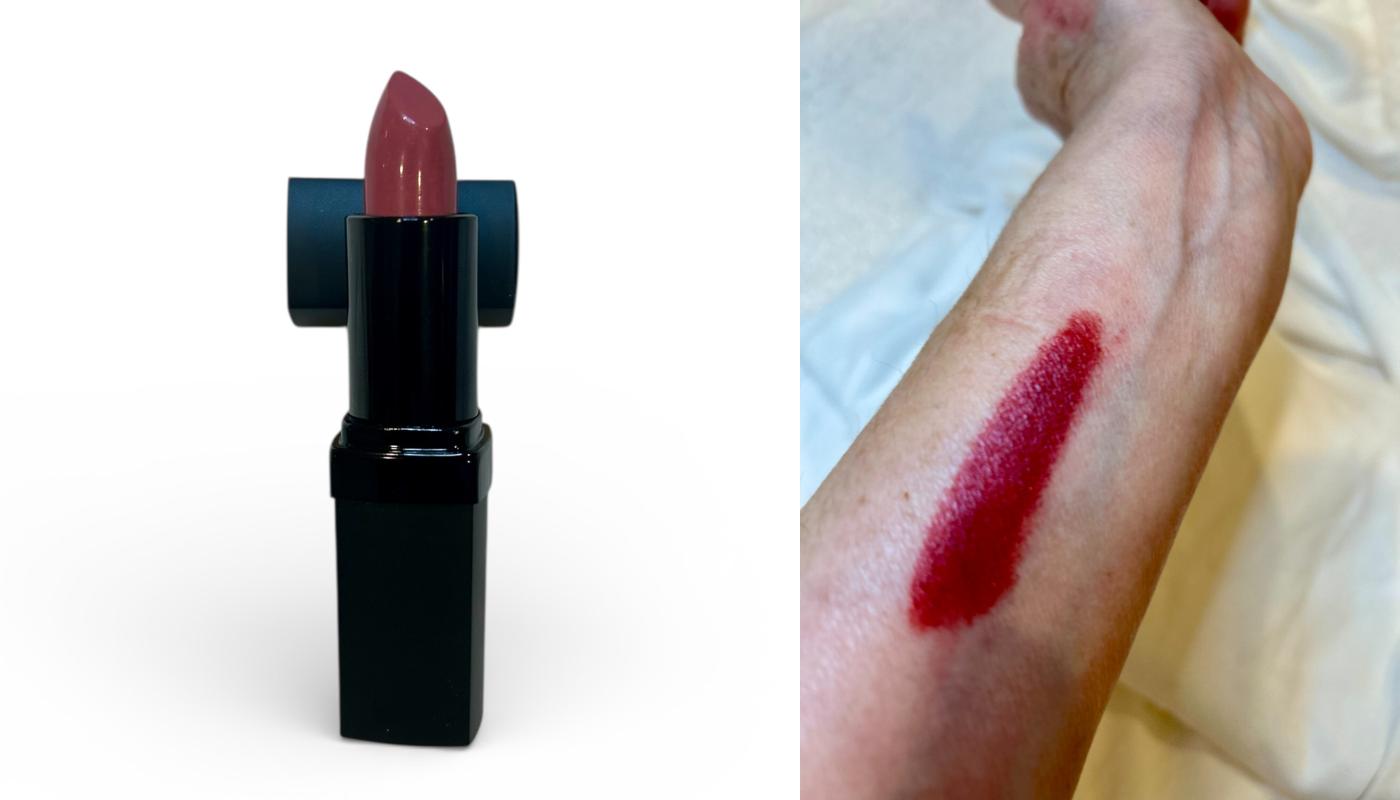 Lipstick with a swatch on skin, showing color application.