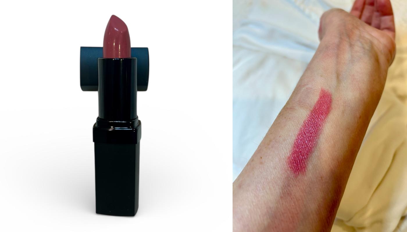 Lipstick with a swatch on a person's arm, showing color application.